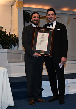 two people posing with an award