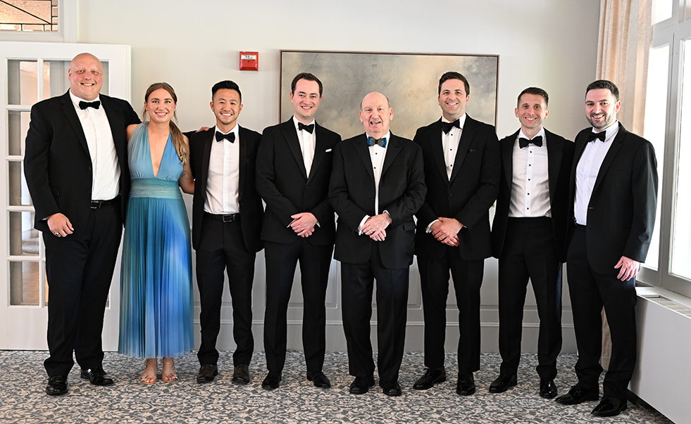 several people in fancy attire posing for a photo