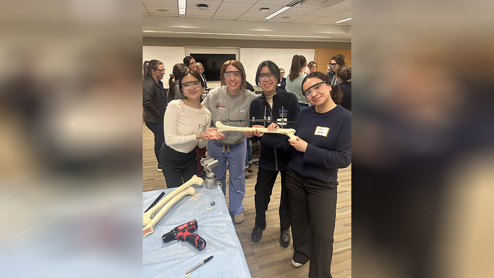 four residents holding up a bone to display