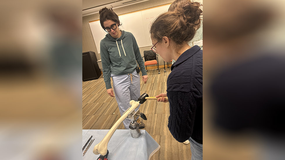 two residents looking at a bone