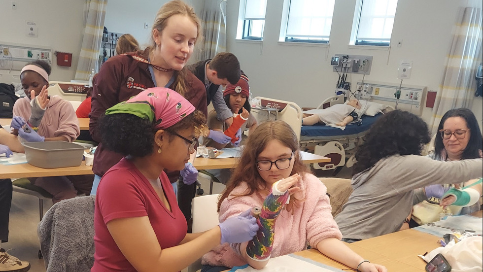person working with young students in a classroom